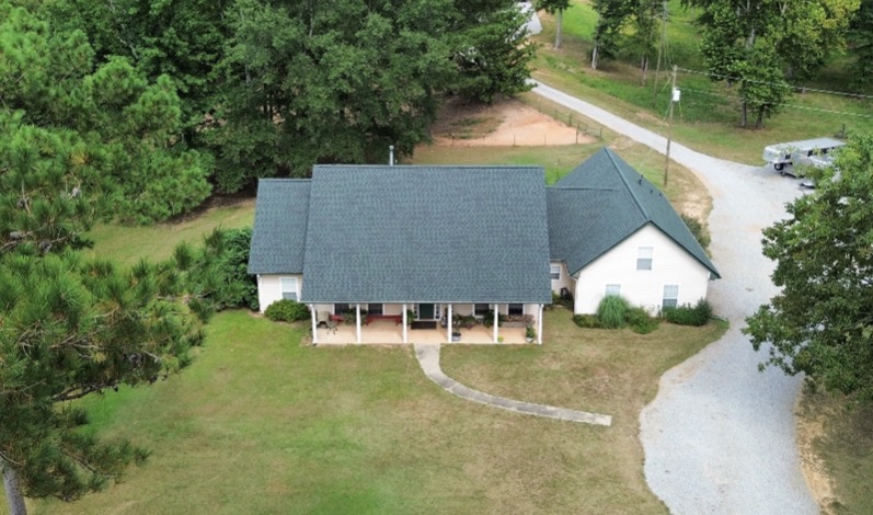 Aerial of a country home with completed slate-gray roof