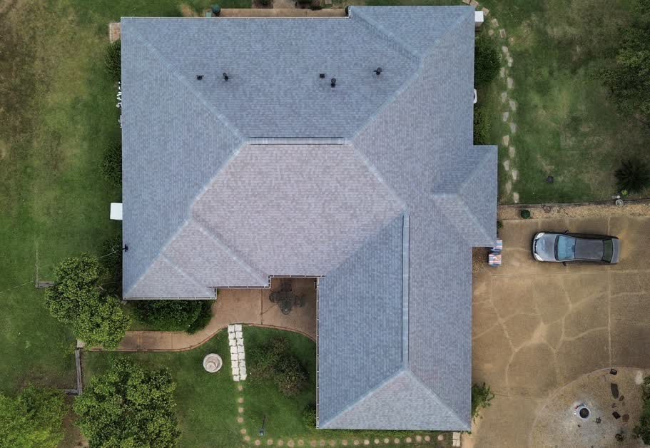 Aerial top-down view of completed stone home roof