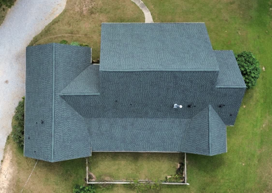 Top-down drone view of finished slate-gray shingle roof