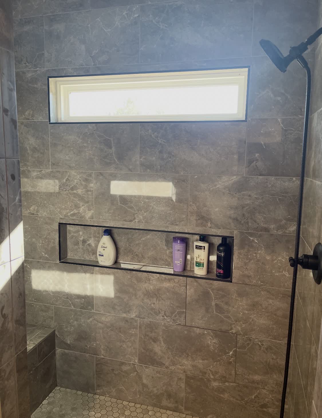 Gray marble shower with built-in shelf niche