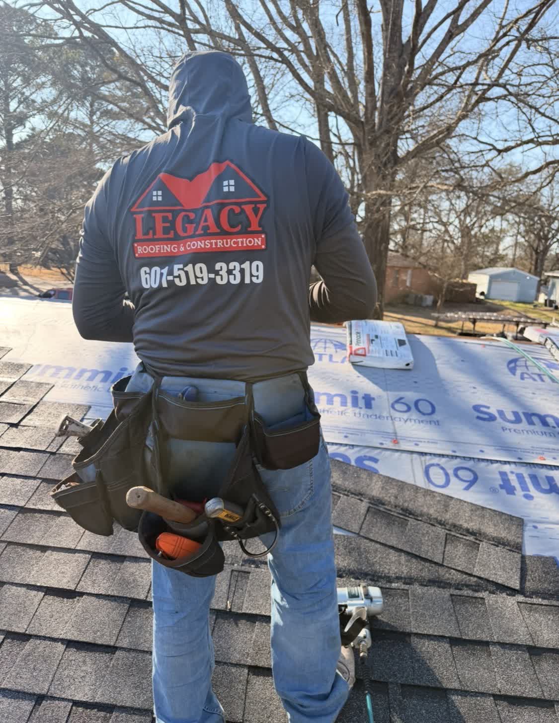Legacy Roofing crew member on a roof in progress