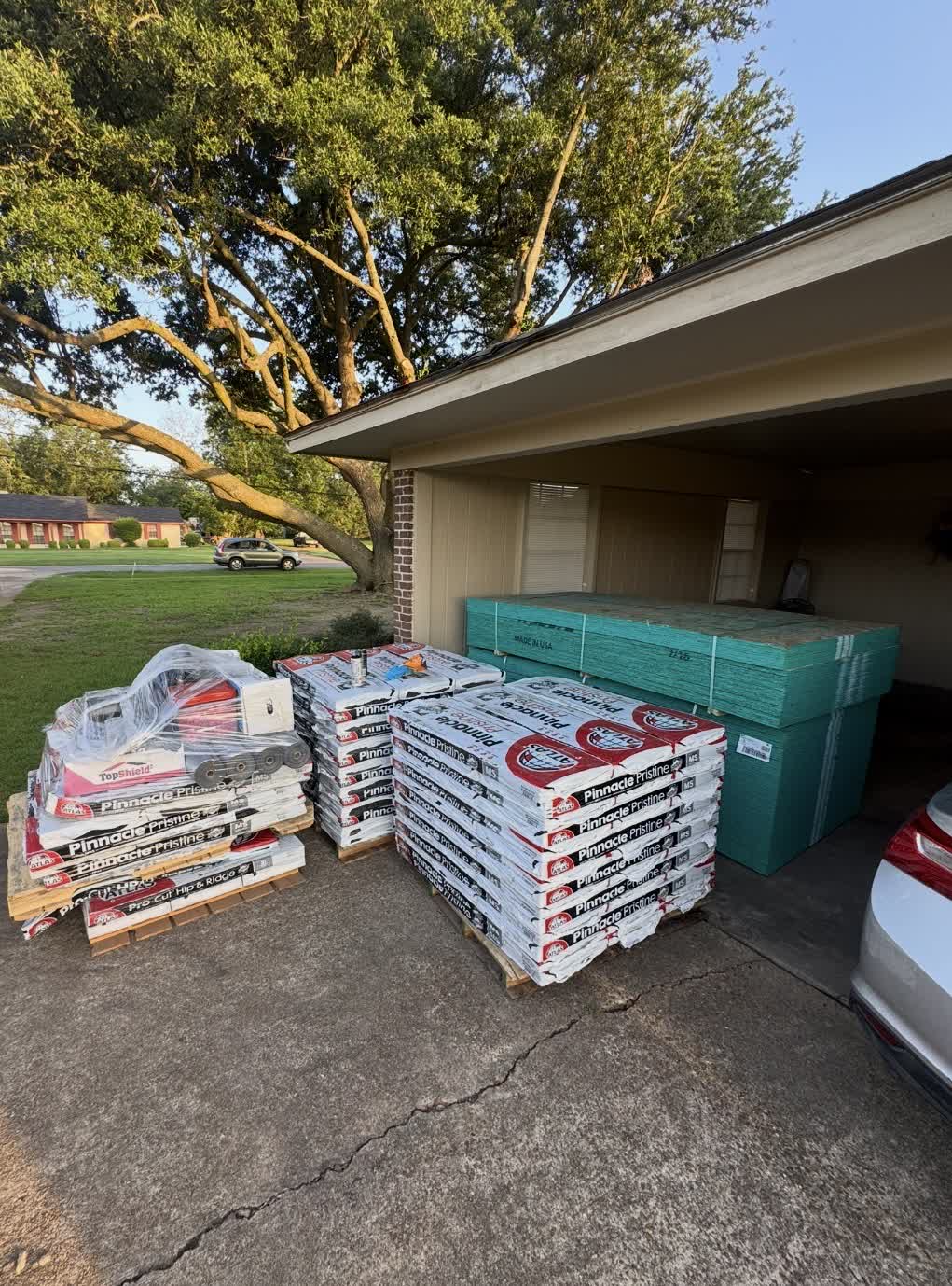 Pinnacle Pristine shingle pallets staged on a driveway