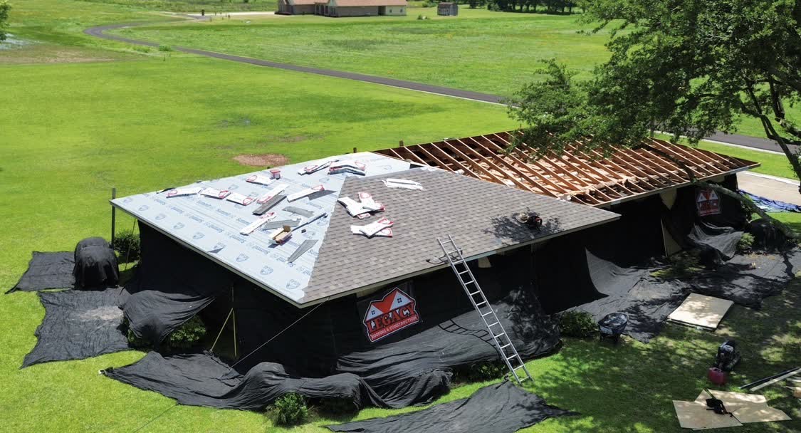 Drone view of in-progress reroof with Legacy yard sign visible
