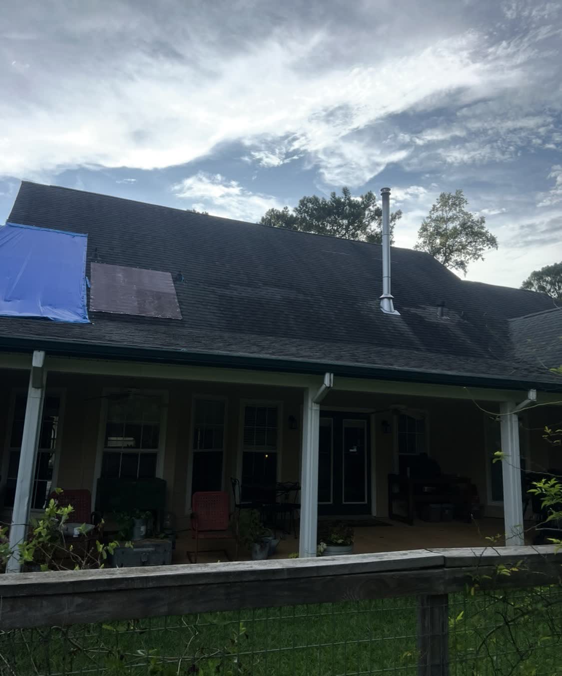 Roof tarped after storm damage, awaiting full restoration